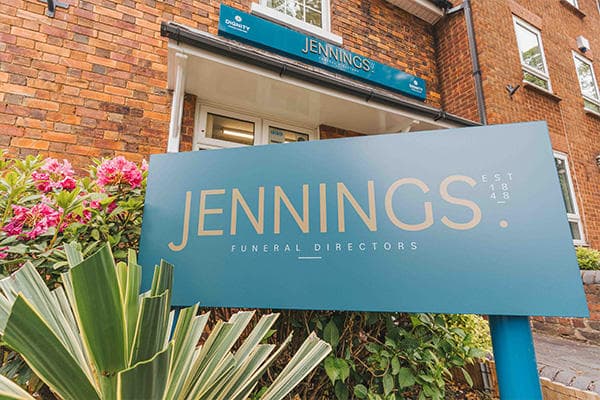 A blue sign displays the Jennings logo outside the Jennings funeral directors branch in Wombourne